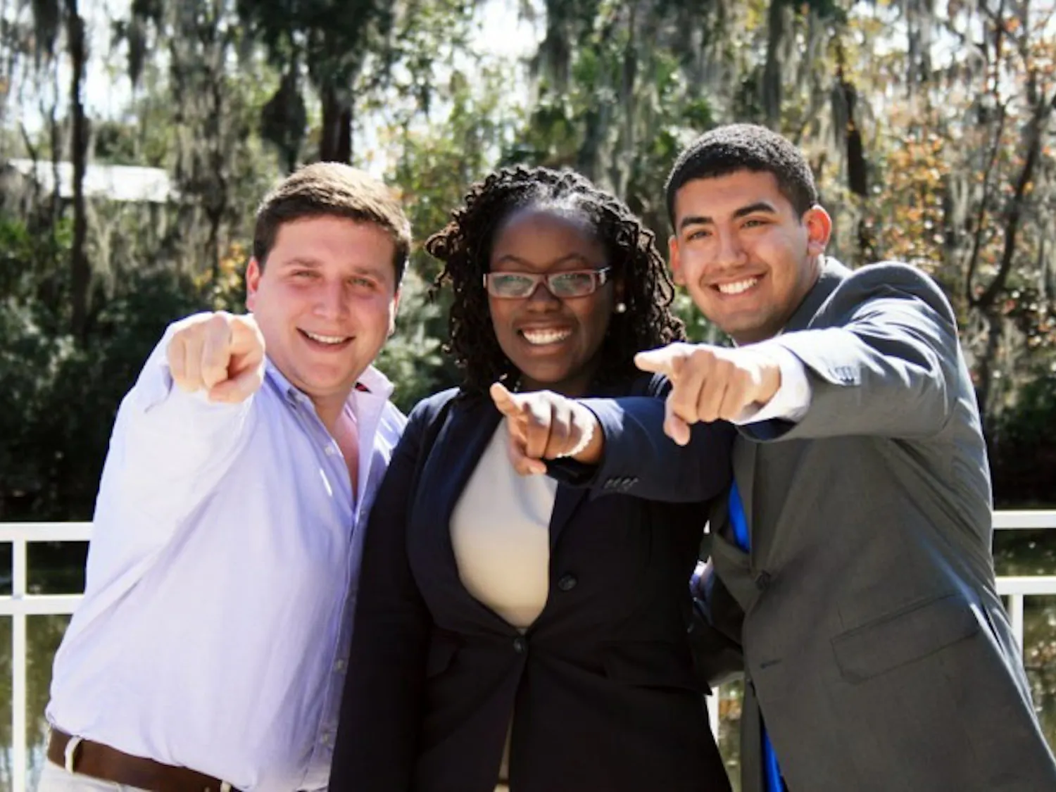 Tj Villamil, Sabine Justilien and Juan Rodriguez pose for another photographer at the Reitz Union Amphitheater on Wednesday afternoon. The three announced that they will be running together on the ballot for the Unite Party elections.