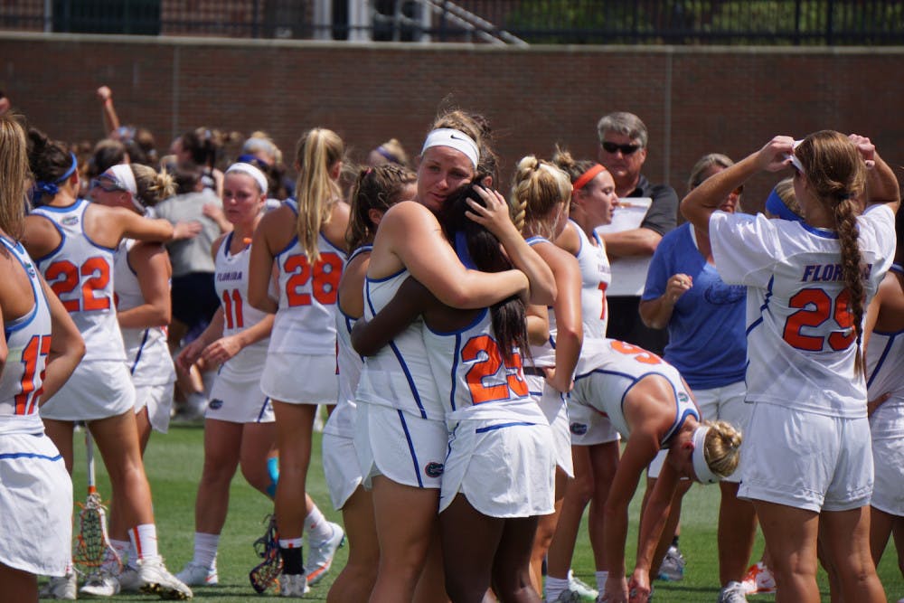 <p>Angela Flister (left) hugs Aniya Flanagan (right) after Florida was eliminated from the NCAA Tournament at Donald R. Dizney Stadium on Sunday.</p>