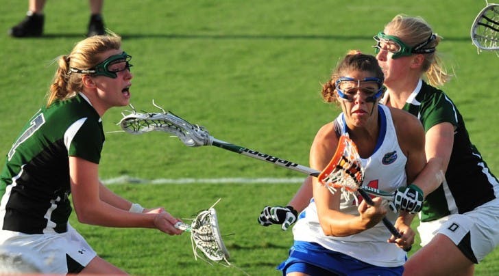 Kitty Cullen (4) drives toward the goal against Dartmouth on March 20. Cullen and Emily Dohony have both suffered head injuries this season but said they do not want helmets to be required.