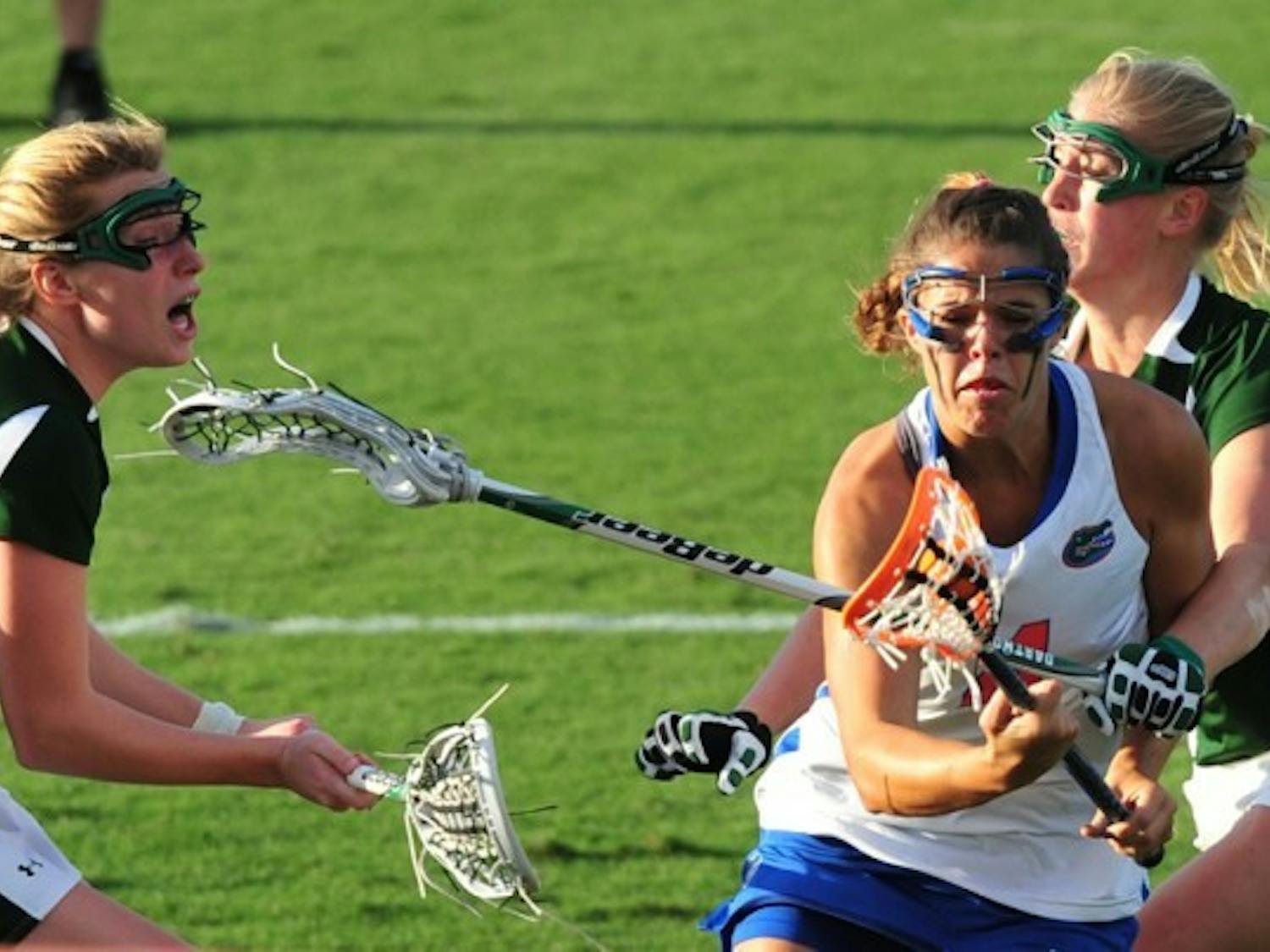 Kitty Cullen (4) drives toward the goal against Dartmouth on March 20. Cullen and Emily Dohony have both suffered head injuries this season but said they do not want helmets to be required.