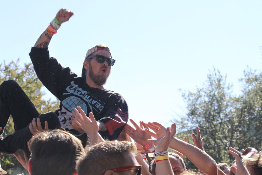 <p class="p1">Hands reach out in support of a crowd surfer Nov. 1, 2014, during Iron Chic’s set on Bo Diddley Community Plaza. The plaza saw thousands of people throughout the weekend.</p>