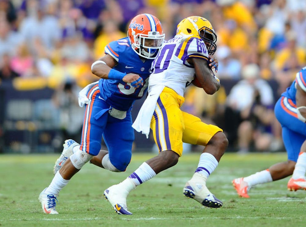 <p>Cody Riggs (31) tackles LSU junior wide receiver Jarvis Landry (80) during Florida’s 17-6 loss to LSU on Oct. 12 at Tiger Stadium in Baton Rouge, La.</p>