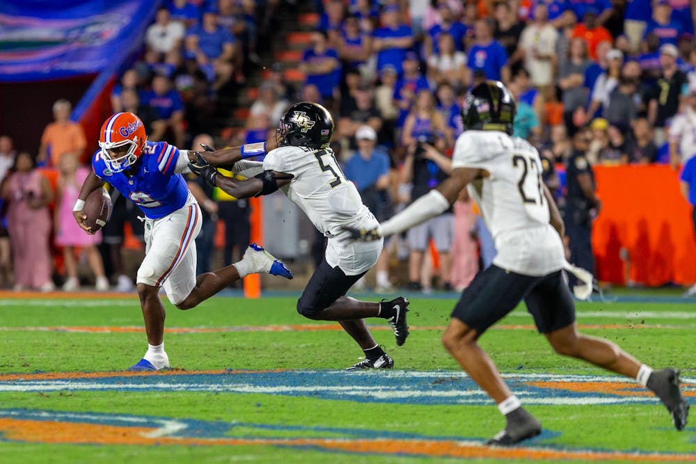 Florida Gators quarterback DJ Lagway (2) stiff arms a defender during the second half half at Steve Spurrier-Florida Field at Ben Hill Griffin Stadium on Saturday, October 05, 2024.