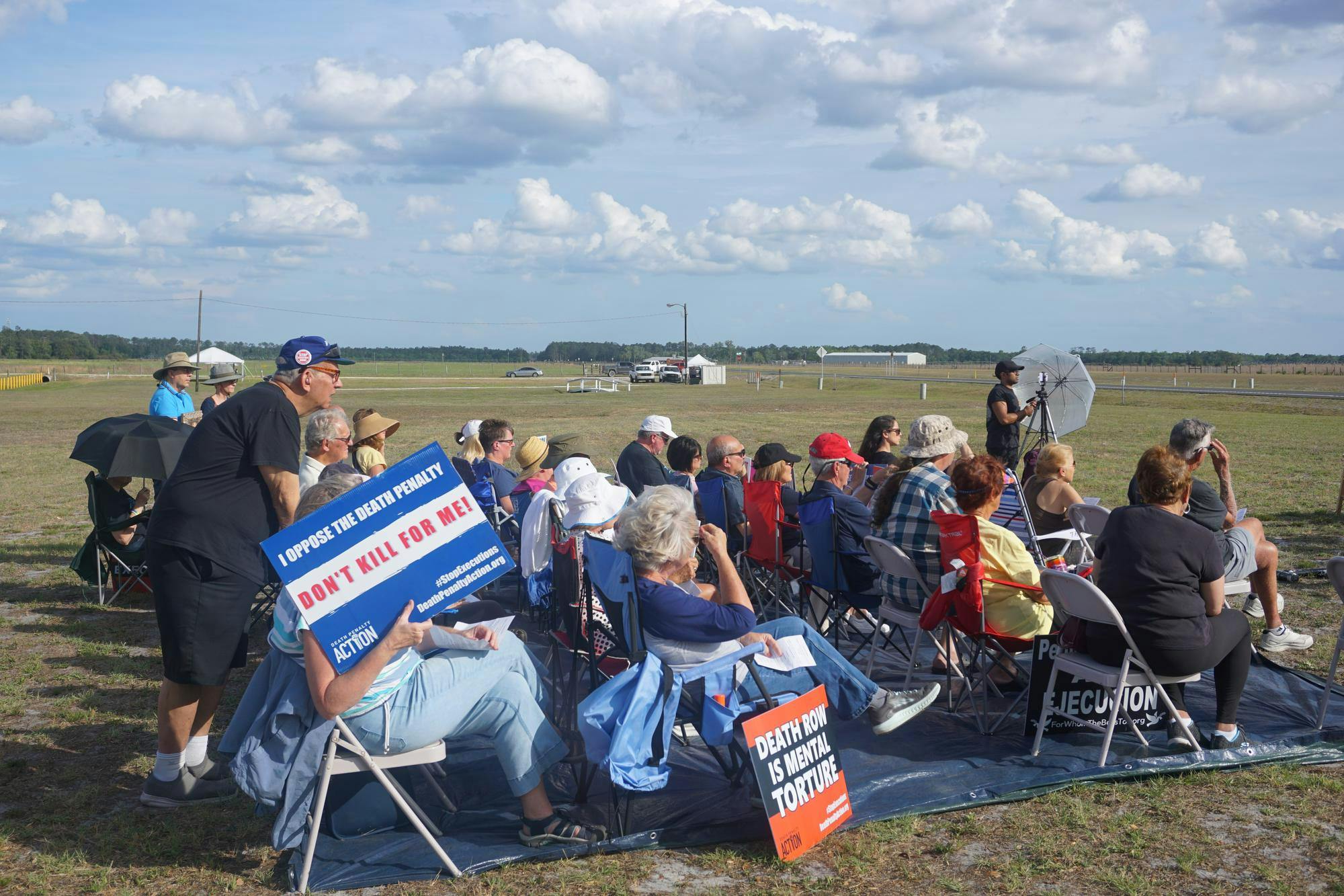 Opponents of the execution sit outside the Florida State Prison, Thursday, April 30, 2026, in Raiford, Fla. 