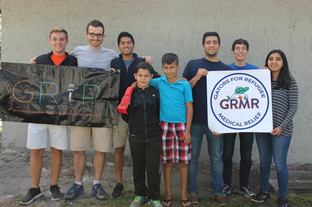 Members of the UF Generational Relief in Prosthetics, also known as GRiP, and Gators for Refugee Medical Relief present Mohammed, a 10-year-old Syrian refugee, with two prosthetic hands.