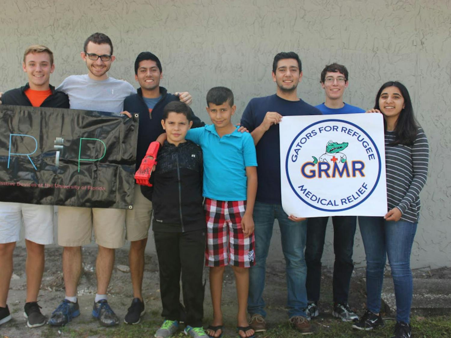 Members of the UF Generational Relief in Prosthetics, also known as GRiP, and Gators for Refugee Medical Relief present Mohammed, a 10-year-old Syrian refugee, with two prosthetic hands.