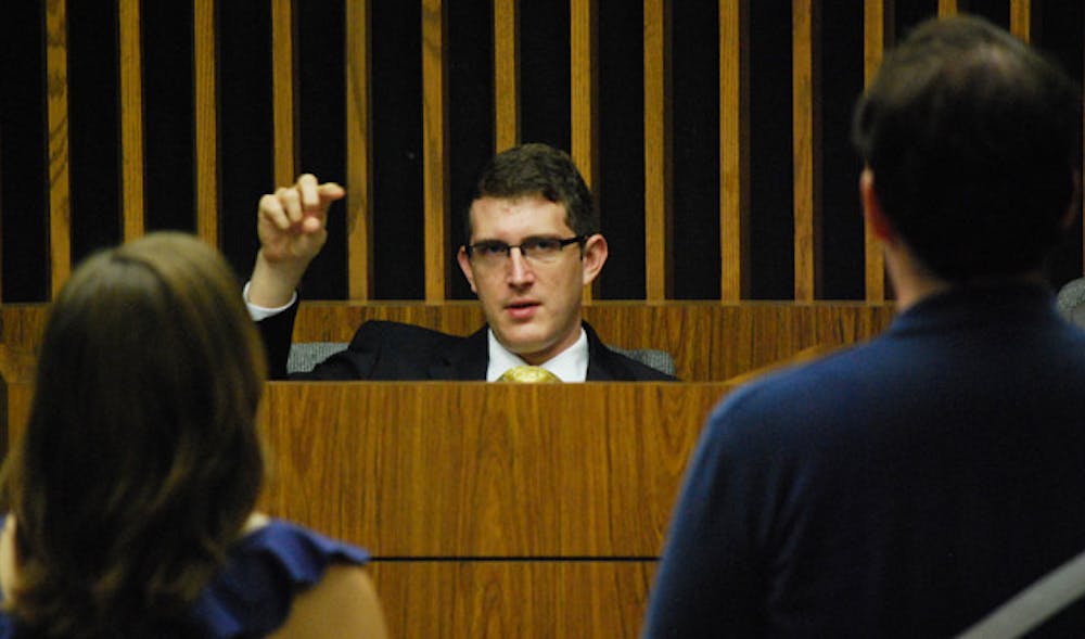 <p>UF Supreme Court Associate Justice Tim Mason questions members of the Election Commission during Monday night's hearing. The Court decided to lift the injunction that had postponed the Student Senate's vote on whether to validate the Student Government elections.</p>