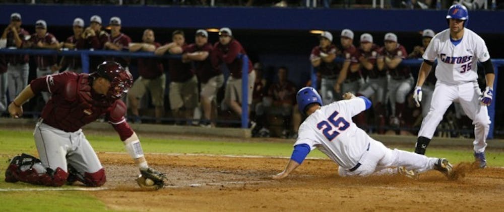 <p>Preston Tucker (25) slides past FSU catcher Stephen McGee during UF’s home win March 13. The two top-five teams meet again tonight at 7 at The Baseball Grounds of Jacksonville.</p>