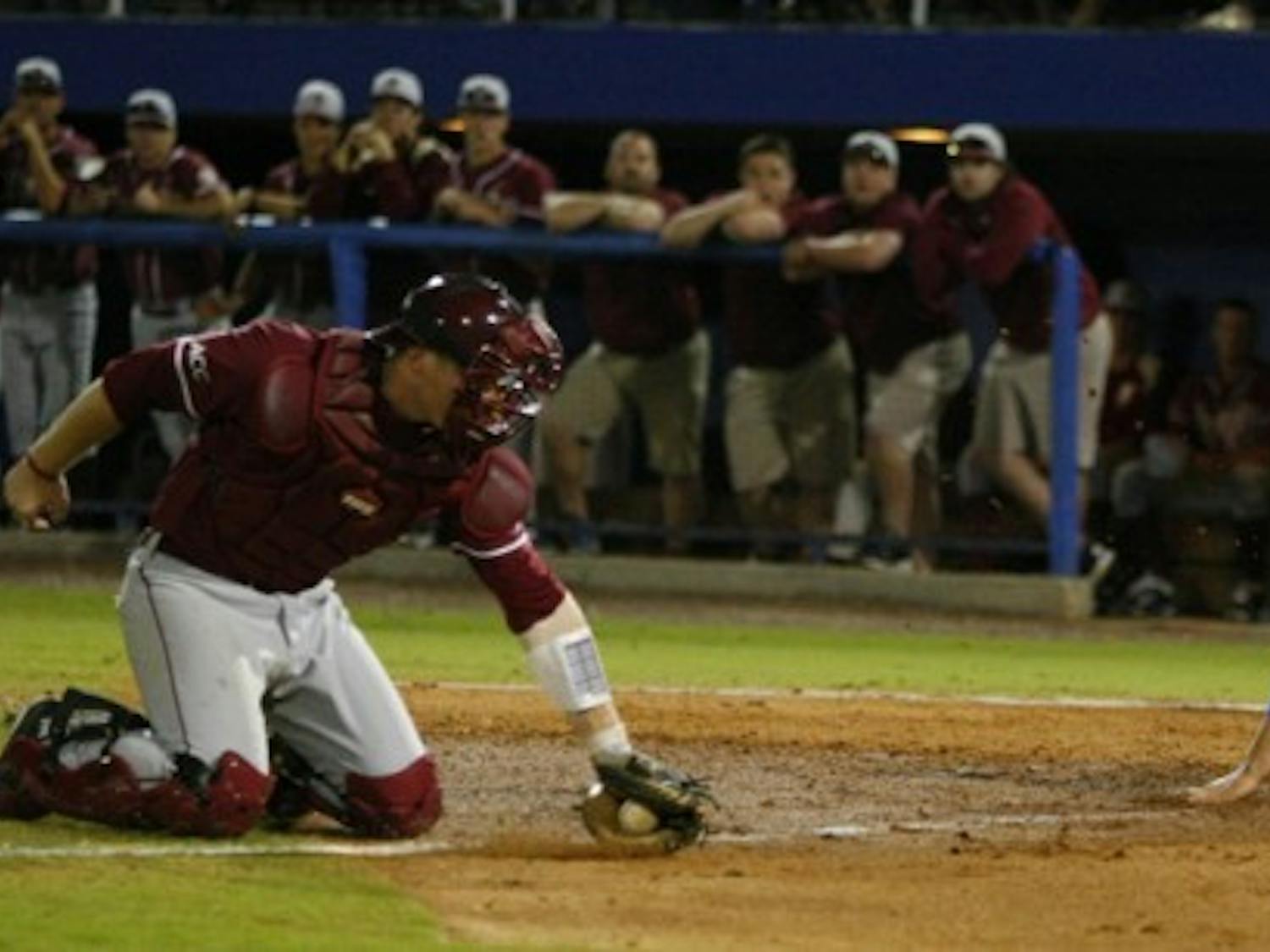 Preston Tucker (25) slides past FSU catcher Stephen McGee during UF’s home win March 13. The two top-five teams meet again tonight at 7 at The Baseball Grounds of Jacksonville.