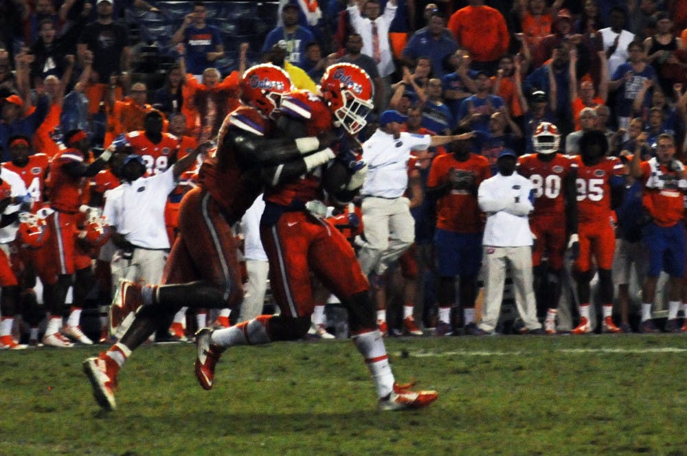 Linebacker Jarrad Davis (left) wraps up teammate Alex McCalister after McCalister recovered a fumble late in the fourth quarter to seal Florida's 31-24 win against East Carolina Sept. 12, 2015, at Ben Hill Griffin Stadium.
