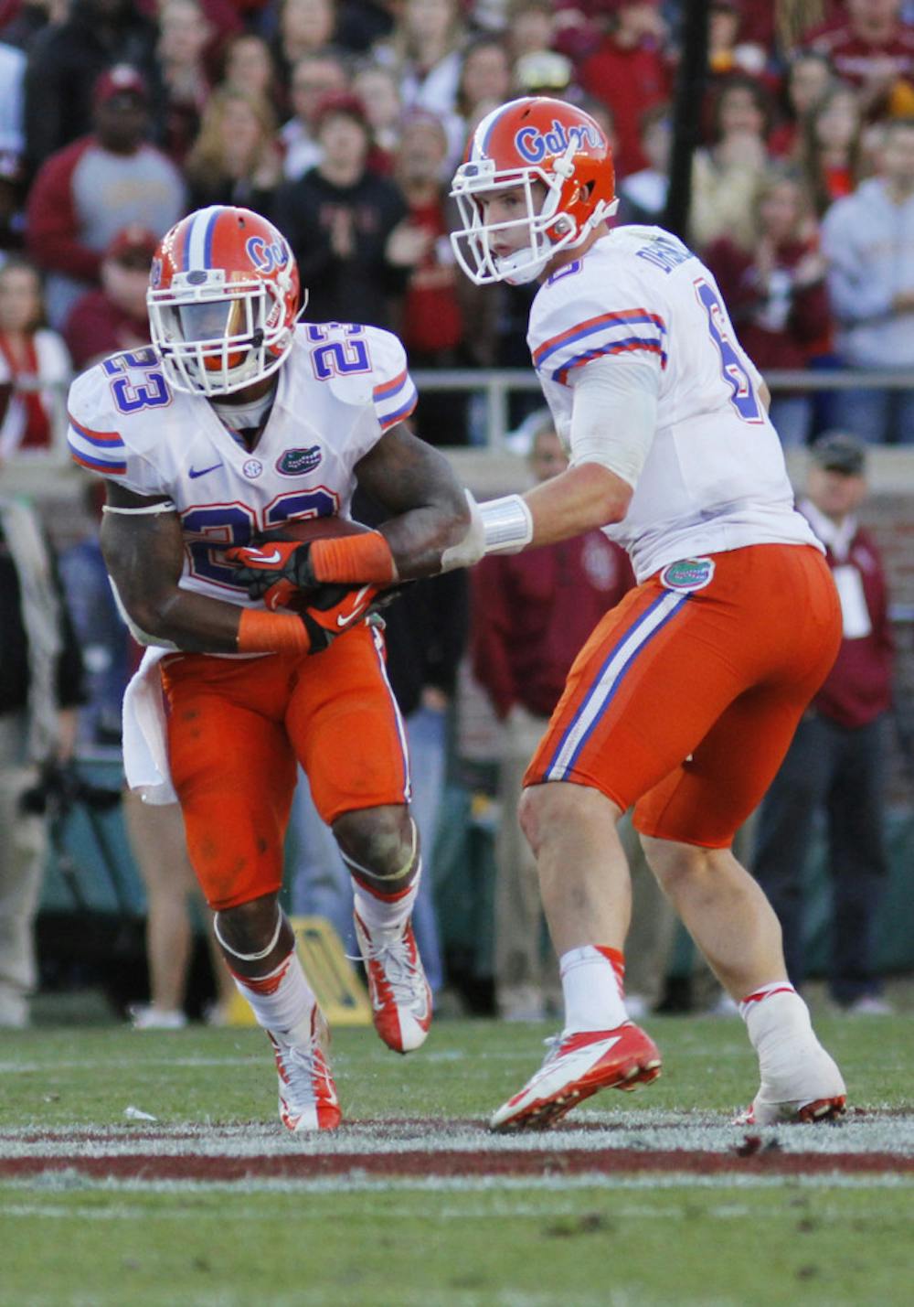 <p>Mike Gillislee (23) takes a handoff from quarterback Jeff Driskel (6) against FSU on Nov. 24. Gillislee ran for 1,152 yards in 2012.</p>