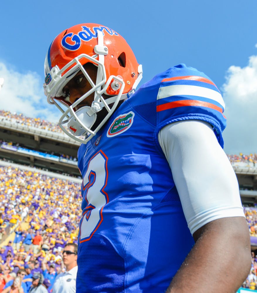 Tyler Murphy heads to the field before playing LSU at Tiger Stadium in Baton Rouge, La., on Oct. 12, 2013. Murphy announced he was transferring from Florida on Dec. 15. 2013, after starting six games for the Gators during a 4-8 season.