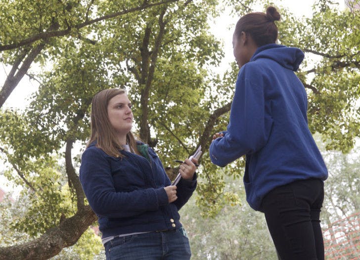 Katherine Brown, a 20-year-old UF journalism sophomore, asks Janaye McGrew, a 22-year-old UF advertising senior, to sign over her First Amendment rights for free food on the Plaza of the Americas on Thursday.&nbsp;