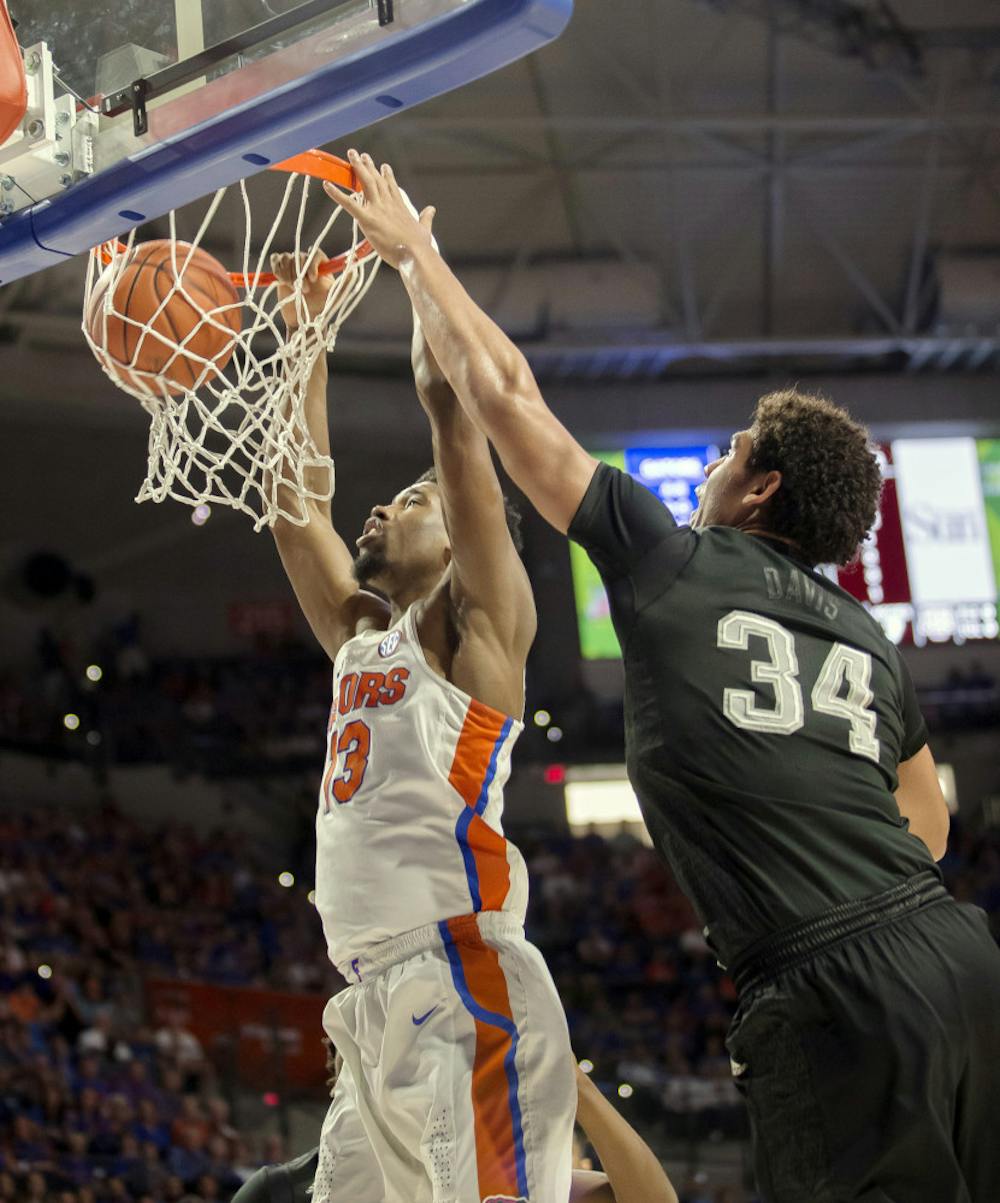 <p>Florida forward Kevarrius Hayes (13) dunks the ball over Texas A&amp;M center Tyler Davis (34) during the first half of an NCAA college basketball game in Gainesville, Fla., Saturday, Feb. 11, 2017. (AP Photo/Ron Irby)</p>
