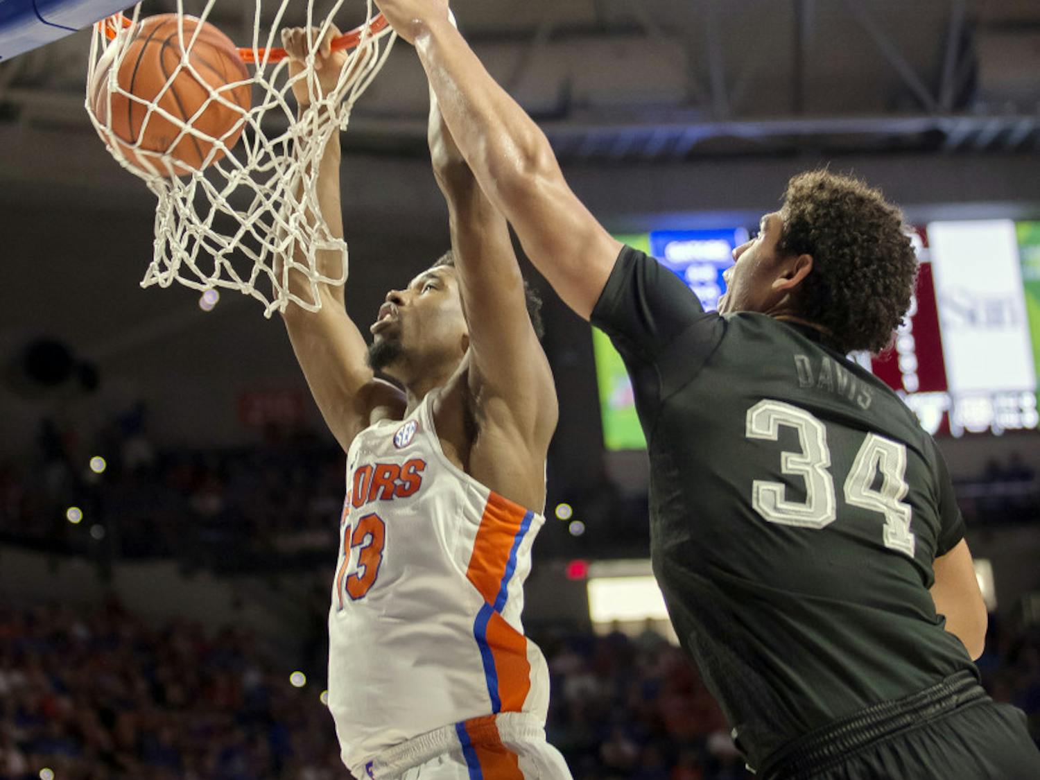Florida forward Kevarrius Hayes (13) dunks the ball over Texas A&amp;M center Tyler Davis (34) during the first half of an NCAA college basketball game in Gainesville, Fla., Saturday, Feb. 11, 2017. (AP Photo/Ron Irby)