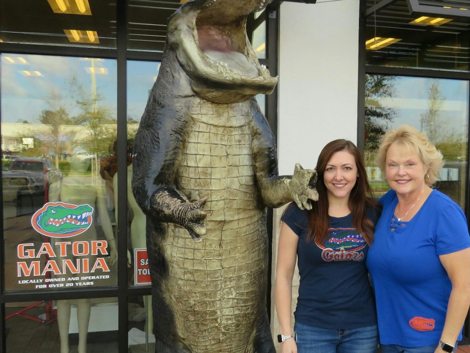 Lisa Blum and Jenice Bushnell stand in front of Gator Mania with their 12-foot fiberglass alligator. [Photo courtesy of Lisa Blum]