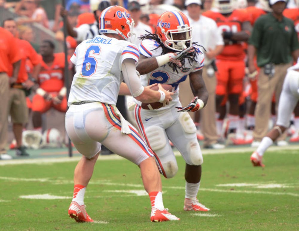 <p>Matt Jones (24) reaches for the ball on a play-action pass from quarterback Jeff Driskel (6) during Florida’s 21-16 loss against Miami on Sept. 7 in Sun Life Stadium.</p>