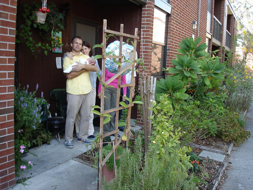 <p>McNair Bostick (left), Luca Bostick-Valero (center) and Carmen Valero-Aracama (right) pictured at their home in University Village South. </p>