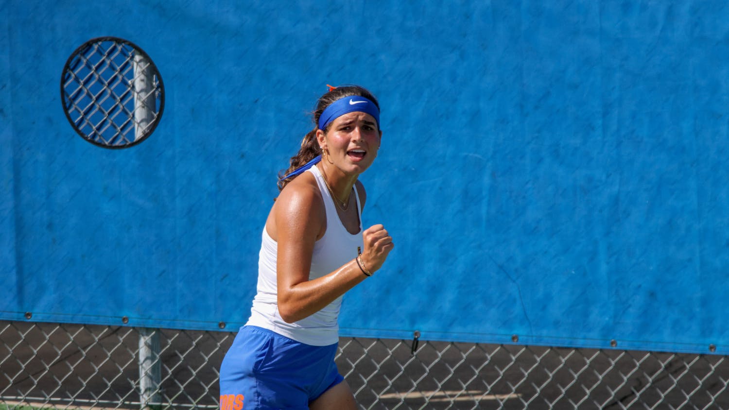 Gators sophomore Emily De Oliveira celebrates after winning a point in a 4-1 victory against the Michigan Wolverines Wednesday, March 22, 2023.
