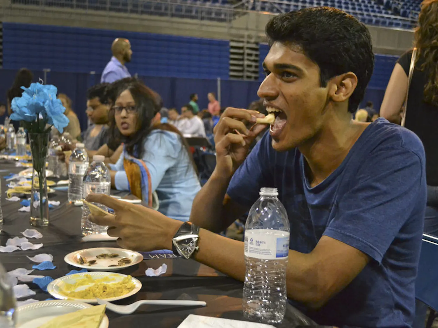 Mickey Vellukunnel, a 26-year-old UF computer science graduate student, breaks his fast with pita bread and hummus. He said the space was a good way for people of different religions to come together and “get a taste of the practice,” an Islamic tradition to cleanse one’s body and spirit.