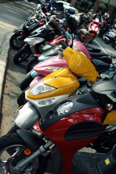Scooters are parked in front of Gator Corner Dining Center during the lunchtime rush Wednesday afternoon.