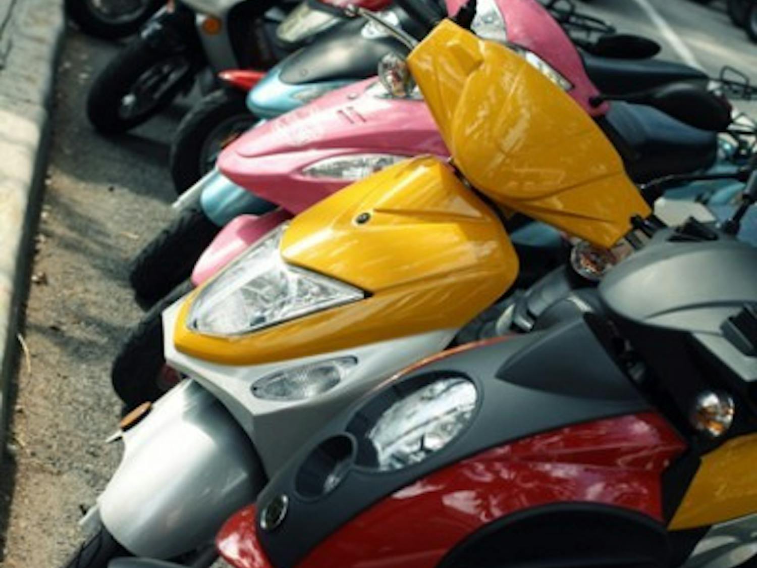 Scooters are parked in front of Gator Corner Dining Center during the lunchtime rush Wednesday afternoon.
