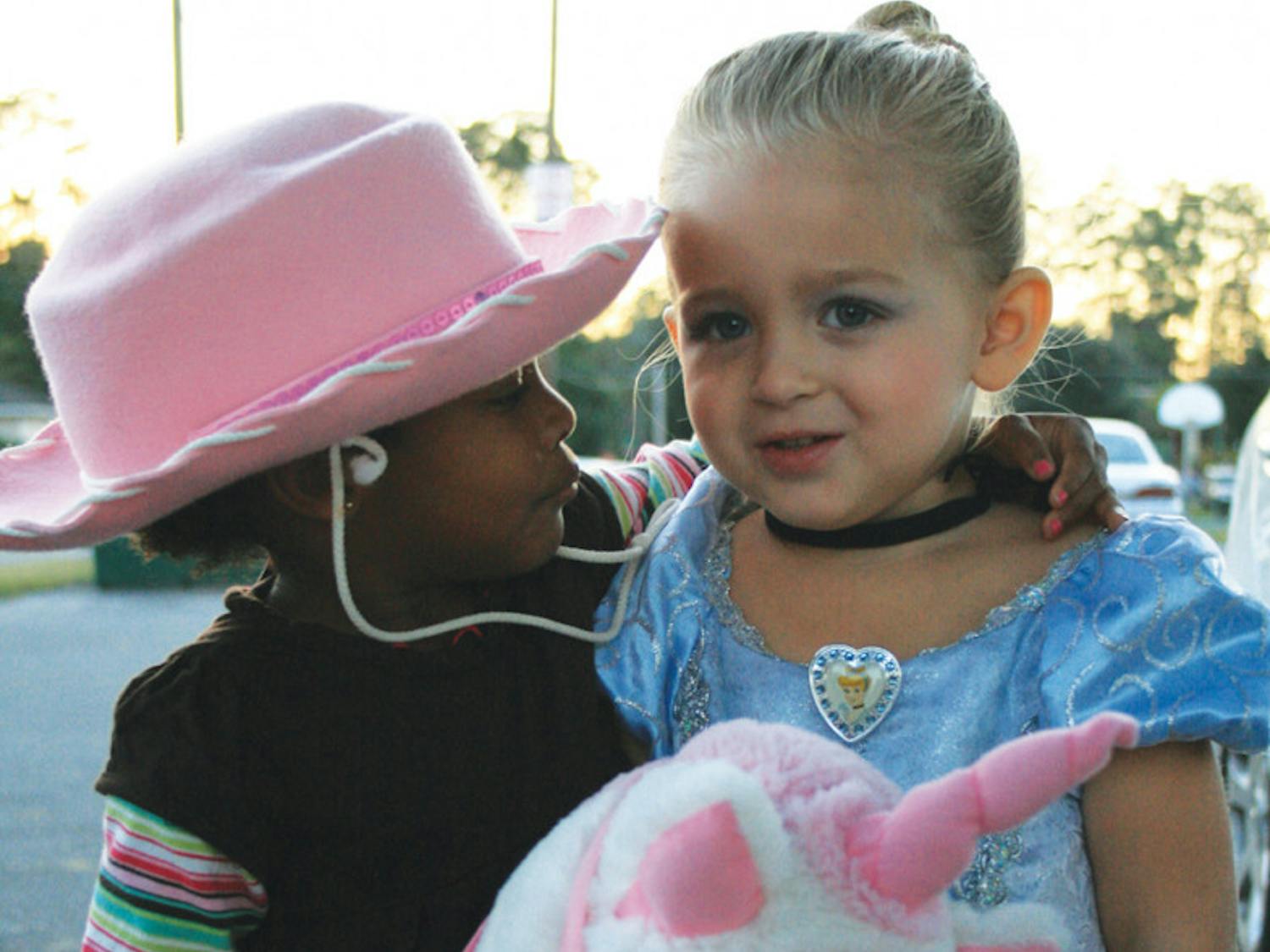 Two-year-old Farrah, right, and Davis spend Halloween together with Williams, Davis’ adopted father, and his mother. Farrah and Davis are cousins, but Williams said they are growing up like sisters.