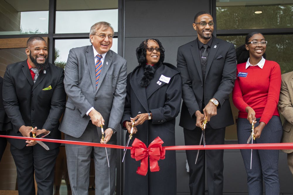 Carl Simien, UF President Kent Fuchs, Betty Stewart-Fullwood, William Atkins and Beaudelaine Mesadieu cut a ribbon Saturday, officially opening up the new Institute of Black Culture. 