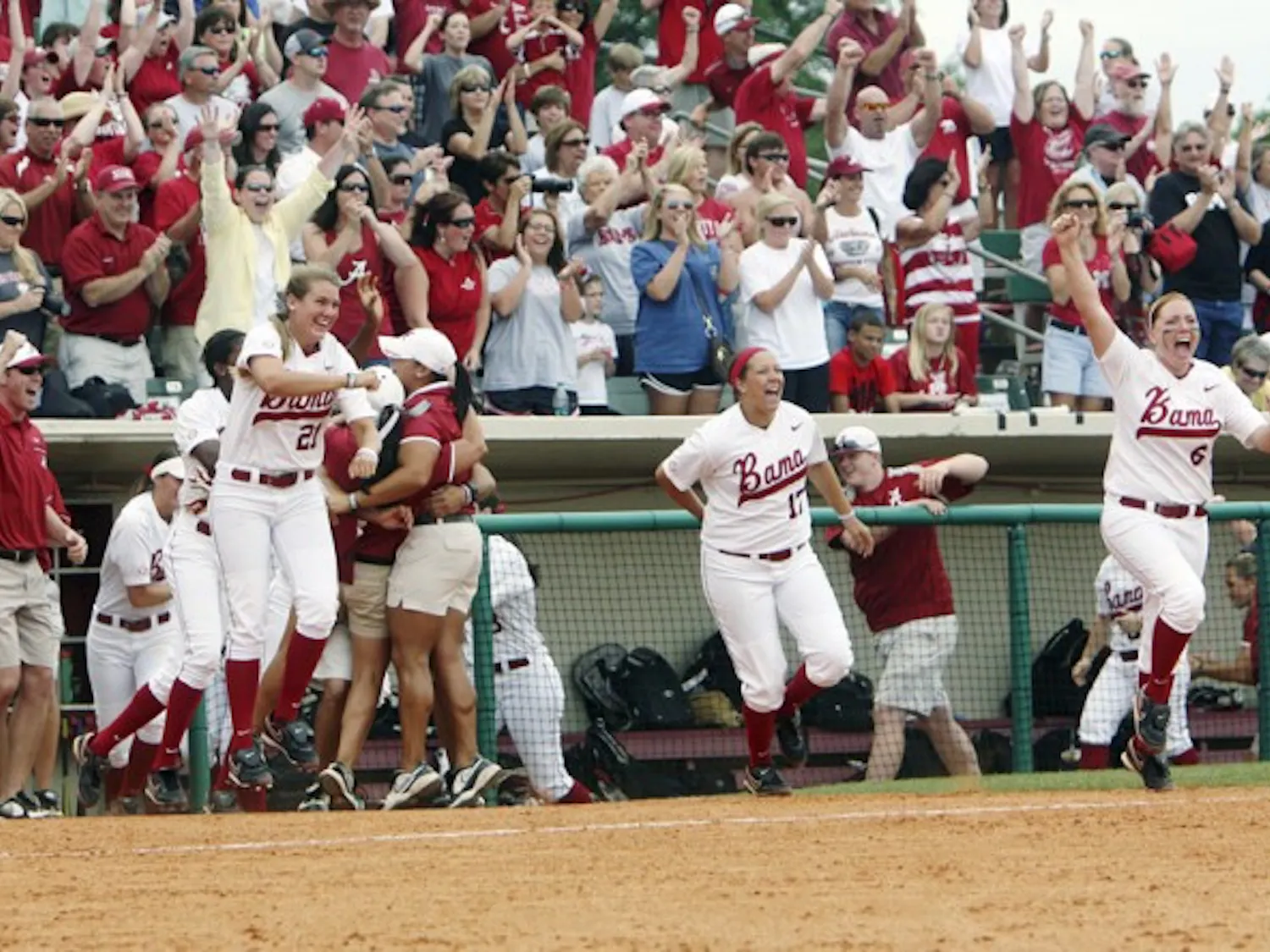 Alabama fans and players celebrate defeating Florida 10-1 in the SEC Tournament final Saturday. The Crimson Tide’s run-rule victory was their third win against the Gators in seven days.