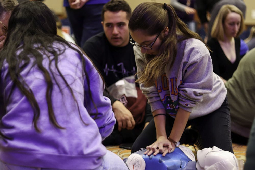 <p><span id="docs-internal-guid-4e95a5a3-7fff-a4e4-162c-260b2bb3db37"><span>Colleen Maloney, an 18-year-old UF nursing freshman, performs CPR on a mannequin. She said she came for practice and because the training cost only $5.</span></span></p>