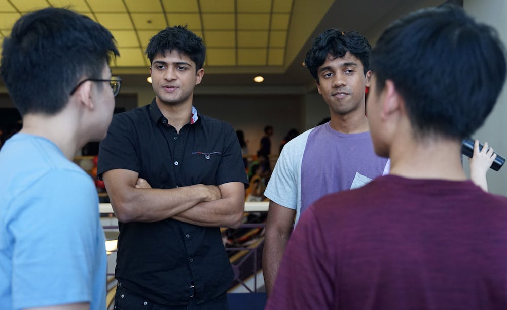 Akshat Pant (left) and Nishant Nagururu (right) promote Candor, an app that connects UF students to Student Government, at the Curtis M. Phillips Center on Saturday, Aug. 26, 2023.