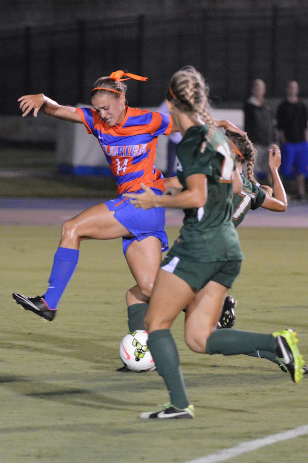 <p>Florida senior forward Jillian Graff fights for possession with two Miami players during the Gators' 3-0 win against the Hurricanes on Friday night at James G. Pressly Stadium. Graff scored the first two goals of the match.</p>