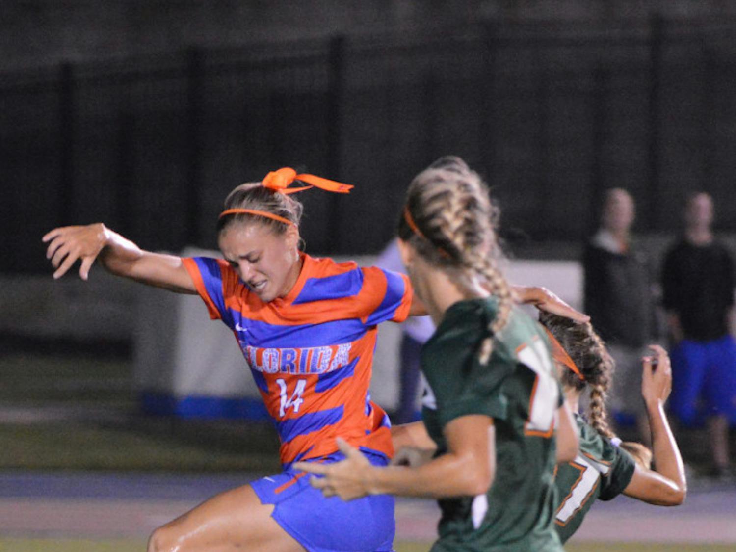 Florida senior forward Jillian Graff fights for possession with two Miami players during the Gators' 3-0 win against the Hurricanes on Friday night at James G. Pressly Stadium. Graff scored the first two goals of the match.