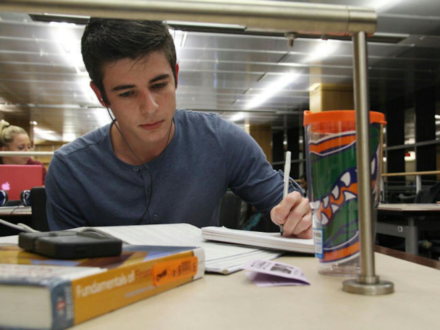 Nick Arena, a 19-year-old UF accounting freshman, reads a textbook at Library West on Monday afternoon.