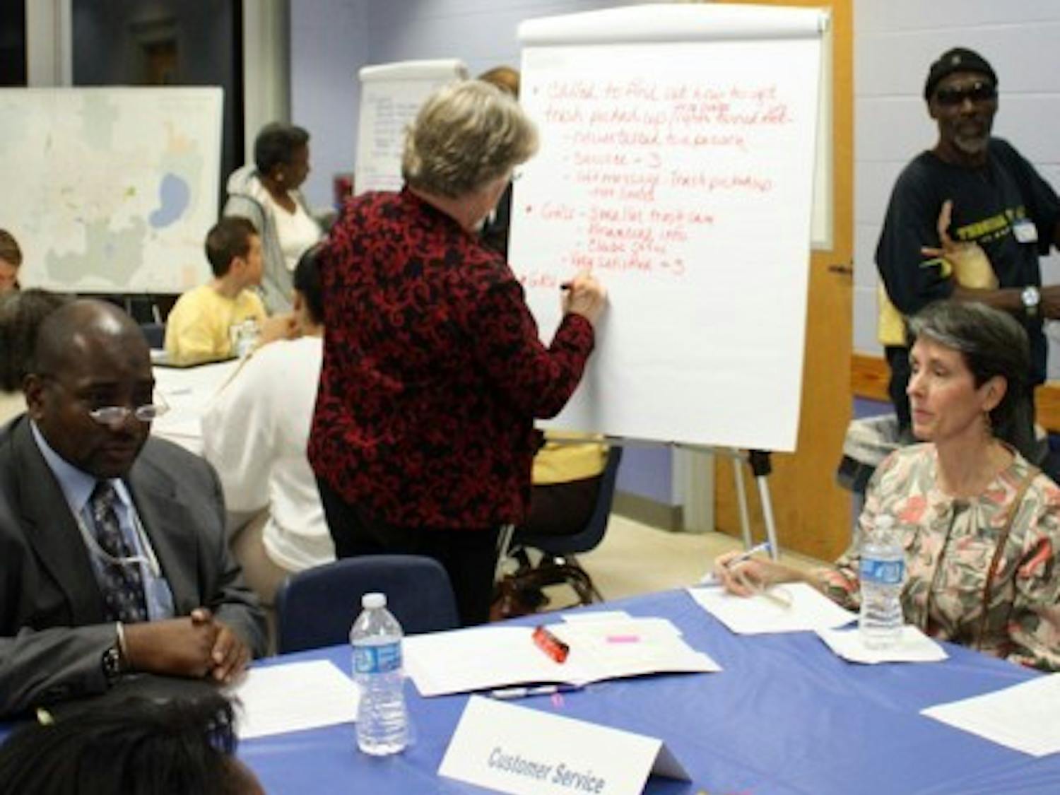 Community members discuss ways the city can improve at the Eastside Recreation Center on Monday evening. Concepts discussed will be presented to the City Commission for the next budget cycle.