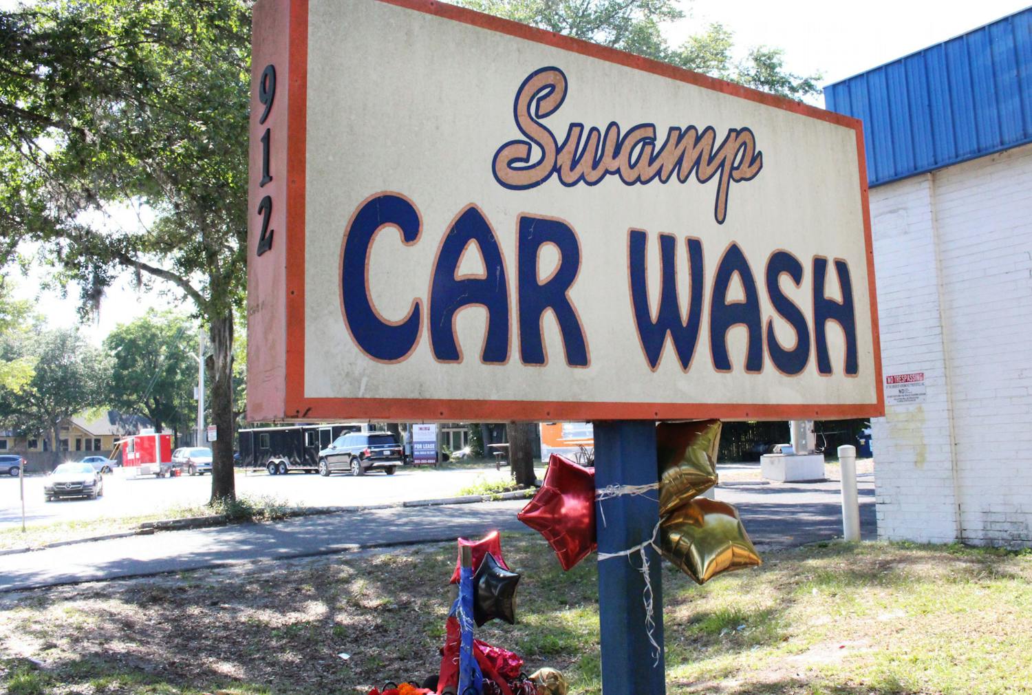 Balloons were tied to the sign of Swamp Car Wash in memory of Bobby Hopkins Jr., on Thursday, May 27, 2021. 