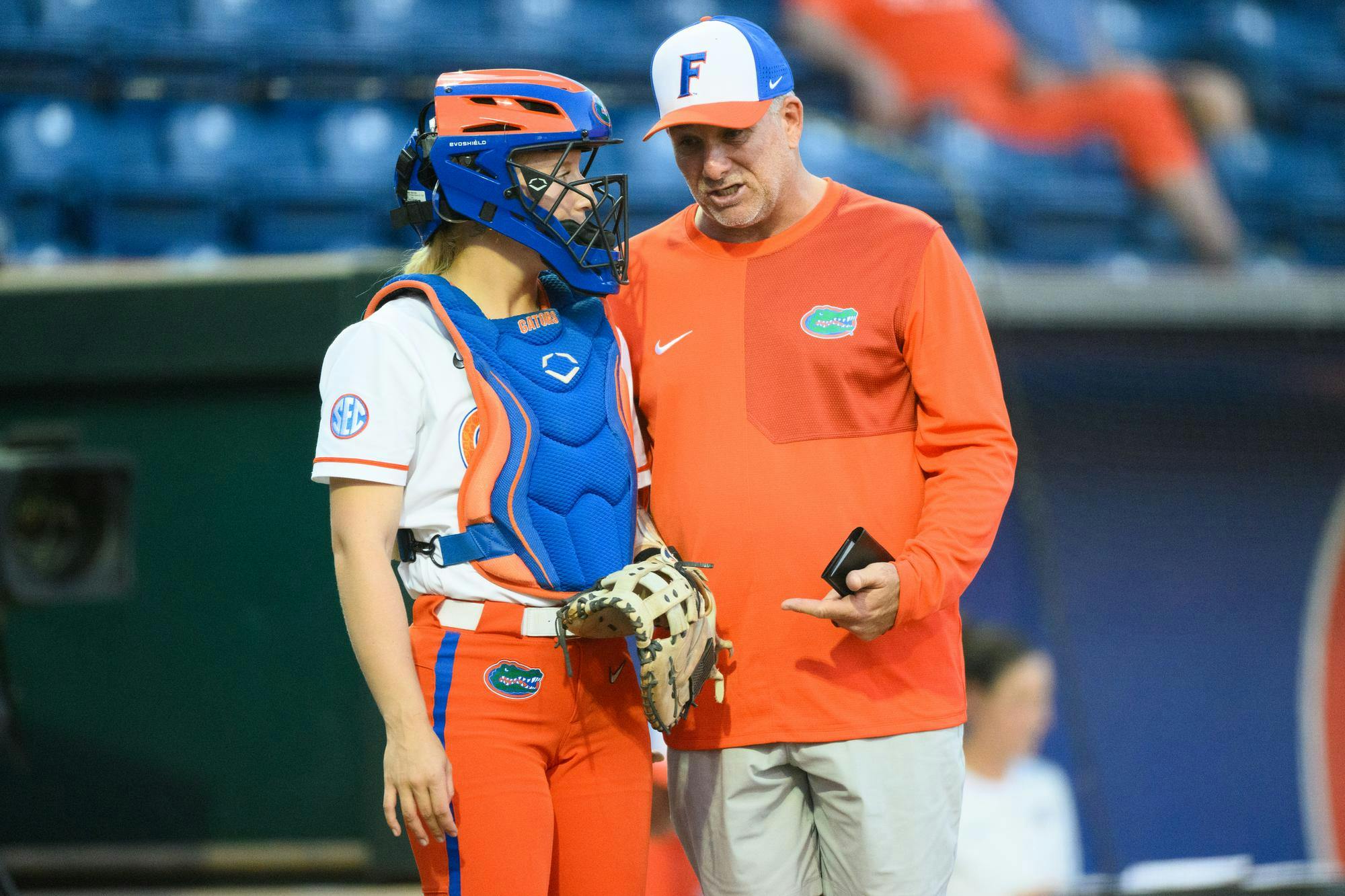 Florida head coach Tim Walton talks to catcher Ella Wesolowski (74) during an NCAA softball game against FGCU, Wednesday, April 15, 2026, in Gainesville, Fla.