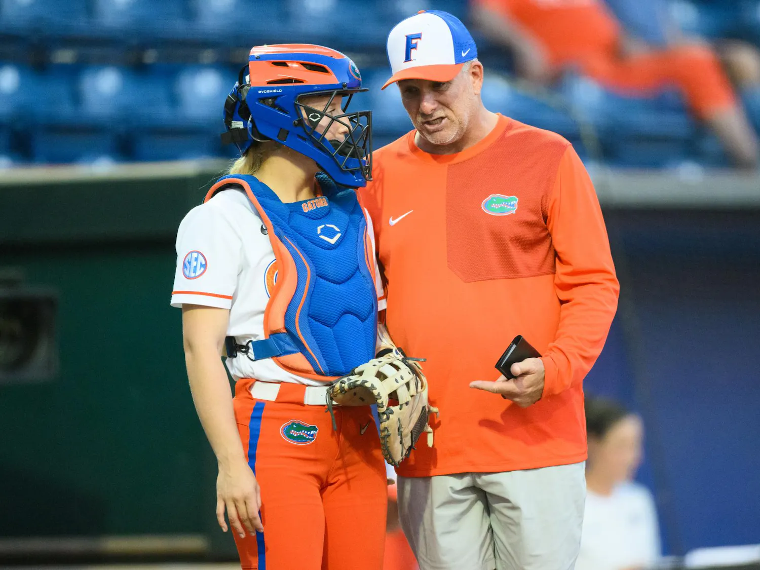 Florida head coach Tim Walton talks to catcher Ella Wesolowski (74) during an NCAA softball game against FGCU, Wednesday, April 15, 2026, in Gainesville, Fla.