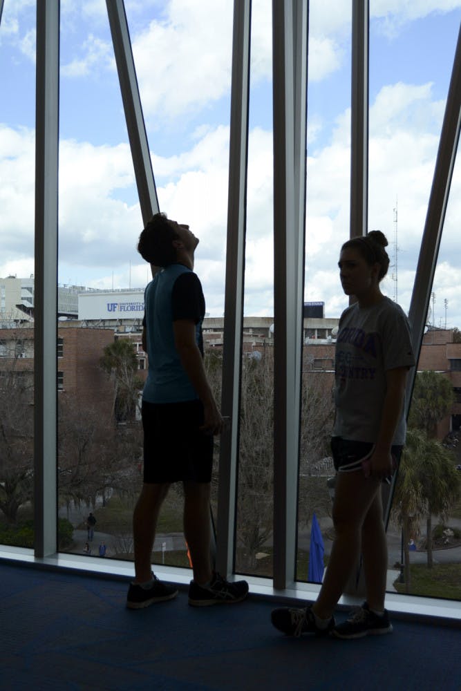 Nick Goble, a 19-year-old UF natural resource conservation freshman, looks out the window of the top floor of the new Reitz Union building while 18-year-old UF journalism freshman Karry Butdorf looks around the room. Goble said they were out exploring the new building.