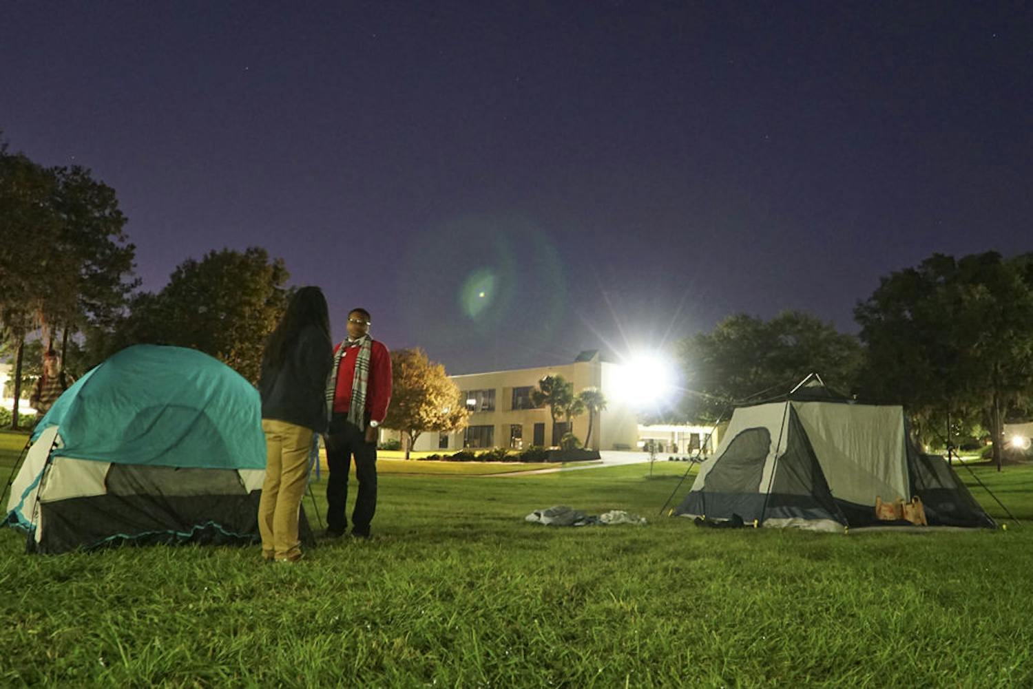 Clarinda Choice (left), a 29-year-old Santa Fe student leadership and activity specialist, and Jacobi Bedenfield, a 19-year-old Santa Fe agriculture freshman, chat under Santa Fe's "Oak Grove" late Nov. 23, 2015. Choice and Bedenfield were two of the five participants raising awareness for homelessness by camping overnight at the college.