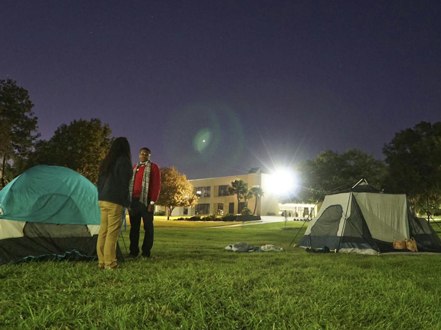 Clarinda Choice (left), a 29-year-old Santa Fe student leadership and activity specialist, and Jacobi Bedenfield, a 19-year-old Santa Fe agriculture freshman, chat under Santa Fe's "Oak Grove" late Nov. 23, 2015. Choice and Bedenfield were two of the five participants raising awareness for homelessness by camping overnight at the college.