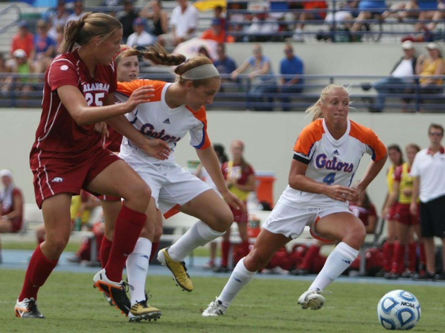 Forward McKenzie Barney (4) pushes the ball past Arkansas forward Lindsey Mayo (25) in UF's 4-0 win on Sunday at James G. Pressly Stadium. Barney scored a goal in her return from injury.