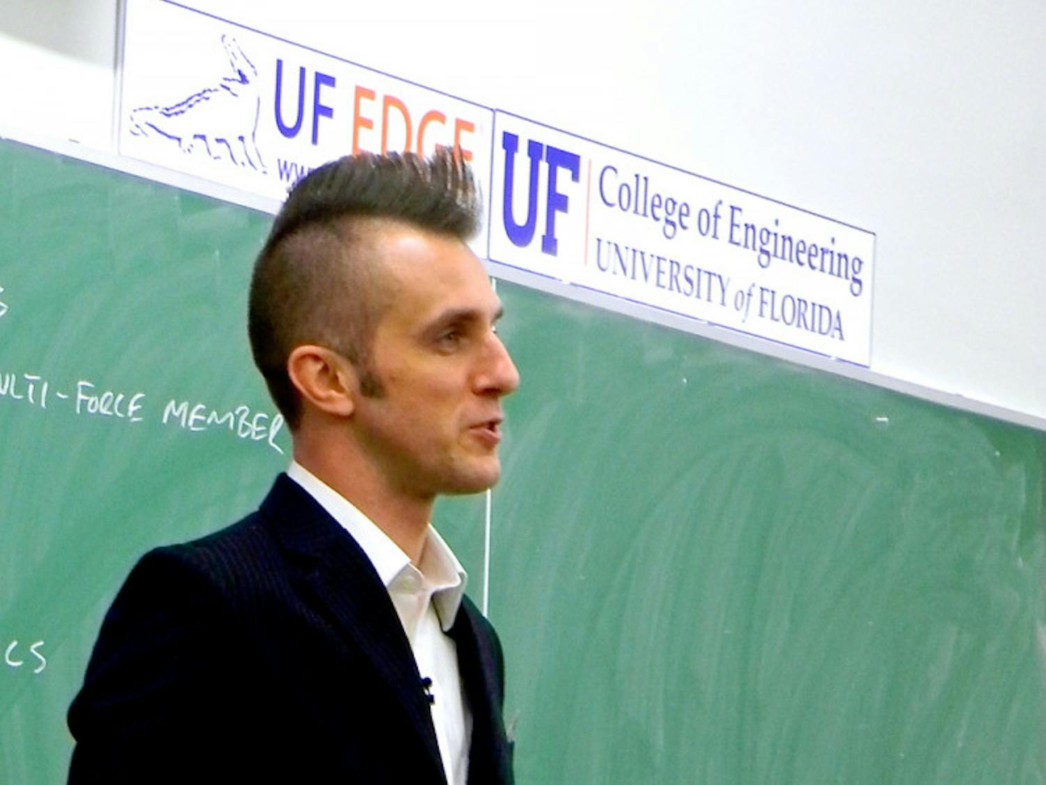 UF engineering professor Dan Dickrell teaches class Wednesday. The professor shaved his hair into a mohawk for basketball season in the style of player Will Yeguete.