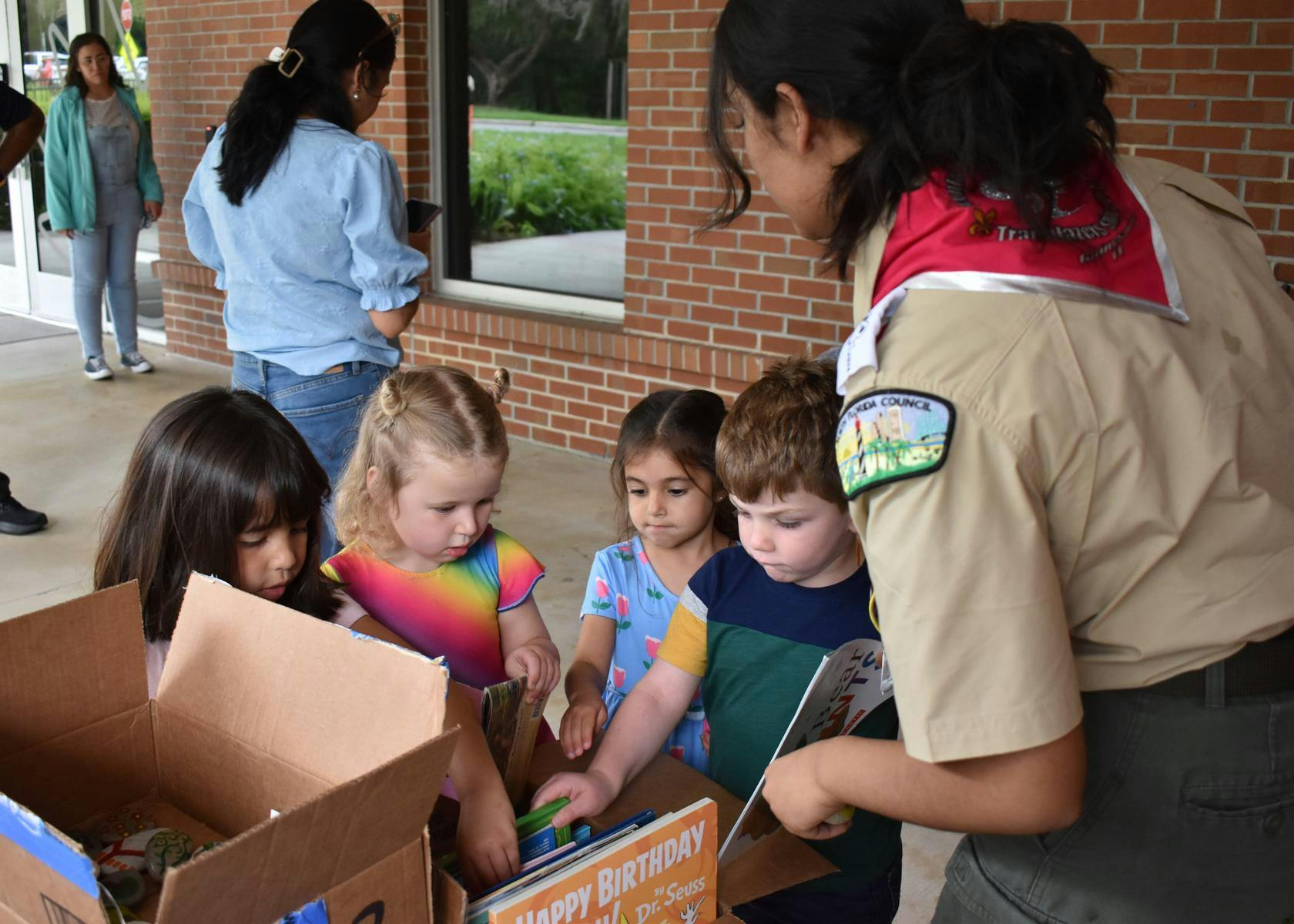 Eagle Scout, Kaayana Sharma, helps Baby Gators pick add books to the new lending library, Thursday, July 30, 2026, at the UF Early Childhood Collaboratory at Diamond Village, in Gainesville, Fla.