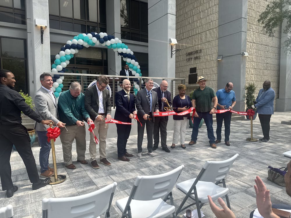 Mayor Harvey Ward is among those at the ribbon cutting for the renovated Gainesville City Hall Plaza Friday, May 8, 2026.