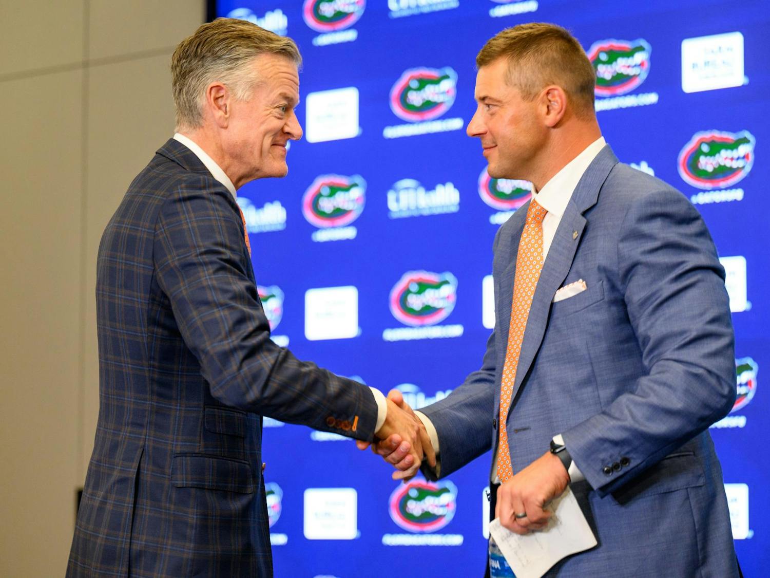 UF’s Athletics Director, Scott Stricklin, shakes Florida head coach Jon Sumrall hand after his introductory press conference at Heavener Football Training Center in Gainesville, Fla., Monday, Dec. 1, 2025.