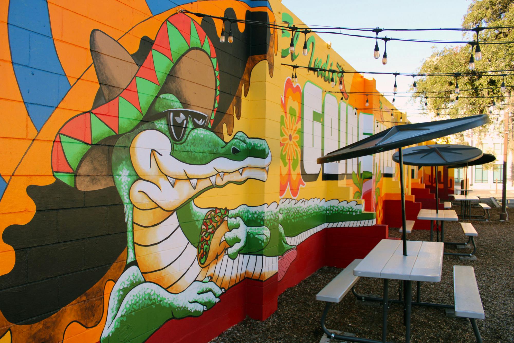 A mural created by Visionary FAM of a sombrero-wearing alligator eating a taco on El Indio Mexican Restaurant&#x27;s side wall Saturday, Jan. 14, 2023. 