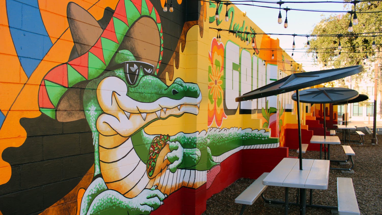 A mural created by Visionary FAM of a sombrero-wearing alligator eating a taco on El Indio Mexican Restaurant&#x27;s side wall Saturday, Jan. 14, 2023. 