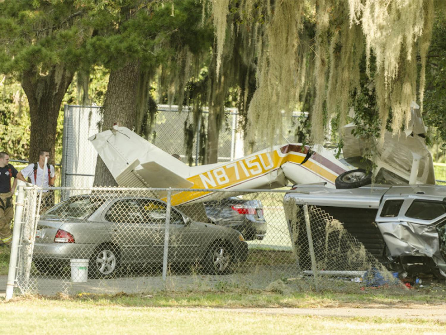 The side of a crashed Cessna 172F Skyhawk is seen Saturday afternoon on Flavet Field.