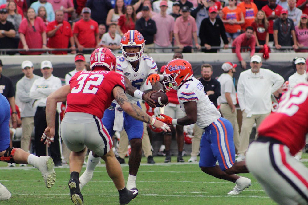 <p>Gators quarterback Anthony Richardson hands off the ball to freshman running back Trevor Etienne during the Florida-Georgia game Saturday, Oct. 29, 2022.</p>